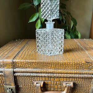 Elegant crystal glass decanter with stopper.